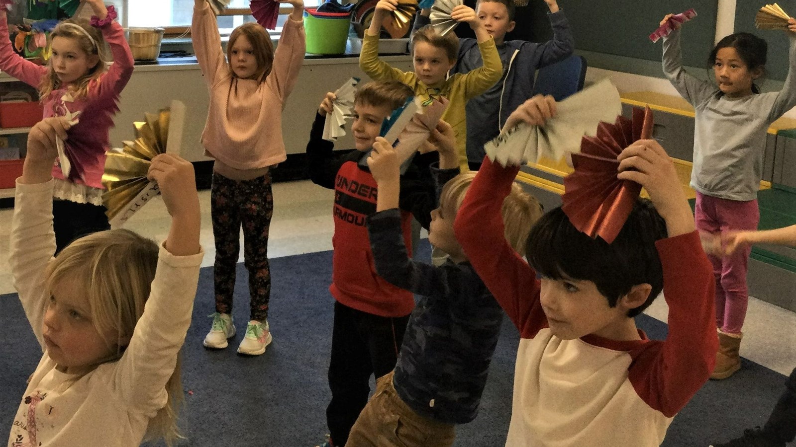 Students dancing with fans